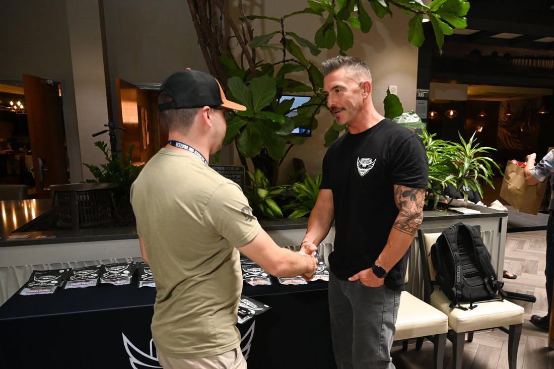 Jarrod, founder of Survivor Brands, shaking hands with a veteran at War Heroes on Water